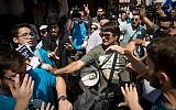 Supporters of the Likud party scuffle with activists from the Democratic Camp alliance at Jerusalem's Mahane Yehuda market on September 13, 2019. (Yonatan Sindel/Flash90)