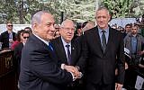 President Reuven Rivlin, Prime Minister Benjamin Netanyahu, and Blue and White leader Benny Gantz shake hands at the memorial ceremony for the late president Shimon Peres, at the Mount Herzl cemetery in Jerusalem, on September 19, 2019. (Yonatan Sindel/Flash90)
