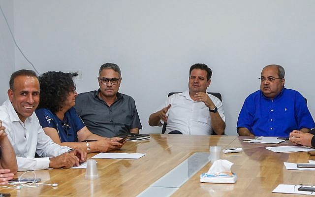 Head of the Joint List party Ayman Odeh (second from right) seen with party members during a faction meeting in Kfar Qasim, on September 21, 2019. (Roy Alima/Flash90) Head of the Joint List party Ayman Odeh (second from right) seen with party members during a faction meeting in Kfar Qasim, on September 21, 2019. (Roy Alima/Flash90)