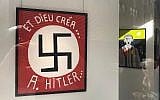 Painting by Fatmir Limani featuring a large swastika at the Bog-Art gallery in Brussels, Belgium. (LBCA via JTA)