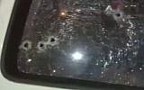 Bullet holes are seen in the window of a car that former state's witness Basel Mustafa Assi was found shot to death in on September 13, 2019, in Kafr Bara. (Screen capture: YouTube)