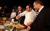 Avigdor Liberman and his son Amos cook with a chef at a food festival held in Jerusalem, March 29, 2011. (Miriam Alster/Flash90)