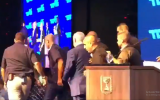 Prime Minister Benjamin Netanyahu taken off stage during a campaign event in Ashdod due to incoming rocket sirens, September 10, 2019. (Screenshot: Twitter)