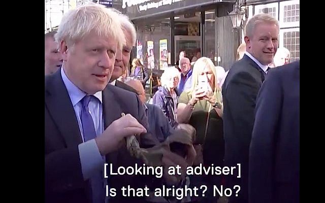 UK Prime Minister Boris Johnson attempts to sound a shofar in video published on September 13, 2019. (Screenshot/Channel 5 News) UK Prime Minister Boris Johnson attempts to sound a shofar in video published on September 13, 2019. (Screenshot/Channel 5 News)
