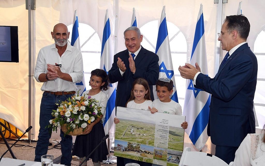 (From L-R) Jordan Valley Regional Council chairman David Elhayani, Prime Minister Benjamin Netanyahu and cabinet secretary Tzachi Braverman applaud after the government authorized the legalization of Mevo'ot Yericho, a West Bank settlement, at the weekly cabinet meeting at the Jordan Valley Regional Council, September 15, 2019 (Haim Tzach/GPO) (From L-R) Jordan Valley Regional Council chairman David Elhayani, Prime Minister Benjamin Netanyahu and cabinet secretary Tzachi Braverman applaud after the government authorized the legalization of Mevo'ot Yericho, a West Bank settlement, at the weekly cabinet meeting at the Jordan Valley Regional Council, September 15, 2019 (Haim Tzach/GPO)