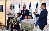 (From L-R) Jordan Valley Regional Council chairman David Elhayani, Prime Minister Benjamin Netanyahu and cabinet secretary Tzachi Braverman applaud after the government authorized the legalization of Mevo'ot Yericho, a West Bank settlement, at the weekly cabinet meeting at the Jordan Valley Regional Council, September 15, 2019 (Haim Tzach/GPO)