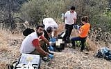 Medics treat a man at the Amud Stream nature reserve after his 11-year-old son directed them to the scene (Magen David Adom)