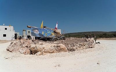 A Hezbollah poster and rocket launchers are seen in a mock Lebanese village as part of an IDF training program in September 2019. (Israel Defense Forces)