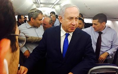 Prime Minister Benjamin Netanyahu on the flight back from Sochi, September 12, 2019. Behind him are Ze'ev Elkin (left) and Meir Ben-Shabbat (to Elkin's right). (Shalom Yerushalmi/Times of Israel)