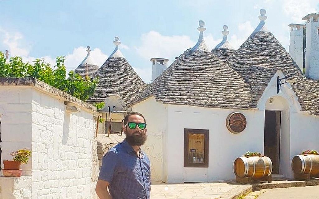 Rabbi Daniel Bortz in front of the white stone huts in Alberobello, Italy. (Courtesy)