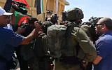 IDF soldiers and Palestinian protesters at the abandoned Lido structure in the northern Dead Sea, September 28, 2019 (Screen grab via Channel 12)