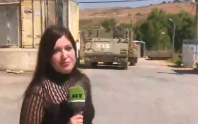 A reporter for the Russian television network RT in Arabic wandering around an empty IDF outpost on the Lebanese border near Avivim, a day after it was struck by Hezbollah missiles. (RT screenshot via Channel 12)