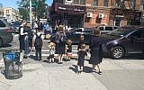 Women and children wait at a crosswalk in the Orthodox neighborhood of Borough Park, Brooklyn, Sept. 3, 2019. (Ben Sales/JTA)