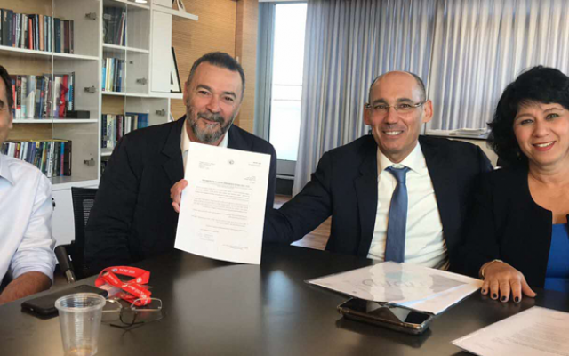 Left to right: Amnon Shashua and Marius Nacht get a letter from Bank of Israel Governor Amir Yaron and Supervisor of Banks Hedva Ber, saying they will get a license to set up a digital bank in Israel (Courtesy) Left to right: Amnon Shashua and Marius Nacht get a letter from Bank of Israel Governor Amir Yaron and Supervisor of Banks Hedva Ber, saying they will get a license to set up a digital bank in Israel (Courtesy)