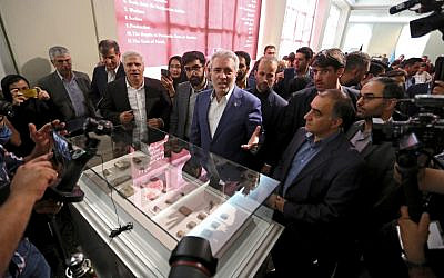 Ali Asghar Mounesan (C), Iran's Minister of Cultural Heritage, Tourism, and Handicrafts, speaks to journalists while viewing Achaemenid-era clay tablets on display at Iran's National Museum in the capital Tehran on October 2, 2019 (ATTA KENARE / AFP)