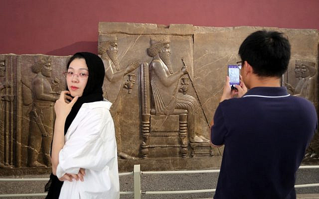A tourist uses his phone to take a picture of the Persepolis relief depicting a historical scene and king Darius while visiting Iran's National Museum in the capital Tehran on October 2, 2019. (ATTA KENARE / AFP) A tourist uses his phone to take a picture of the Persepolis relief depicting a historical scene and king Darius while visiting Iran's National Museum in the capital Tehran on October 2, 2019. (ATTA KENARE / AFP)