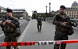 French soldiers stand guard near the police headquarters in Paris on October 3, 2019, after four officers were killed in a stabbing attack. (Bertrand Guay/AFP)