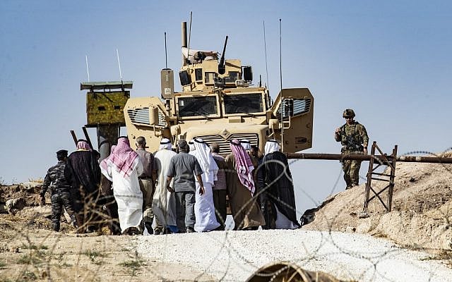 Syrian Kurds take part in a demonstration against Turkish threats at a US-led international coalition base on the outskirts of Ras al-Ain town, in Syria's Hasakeh province near the Turkish border, on October 6, 2019. (Delil SOULEIMAN / AFP) Syrian Kurds take part in a demonstration against Turkish threats at a US-led international coalition base on the outskirts of Ras al-Ain town, in Syria's Hasakeh province near the Turkish border, on October 6, 2019. (Delil SOULEIMAN / AFP)