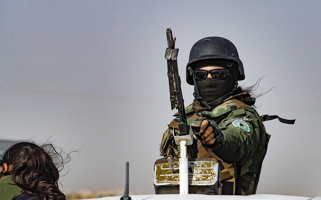 A member of the Kurdish Internal Security Forces of Asayesh stands guard during a demonstration by Syrian Kurds against Turkish threats, in the town of Ras al-Ain in Syria's Hasakeh province near the Turkish border, on October 6, 2019. (Delil Souleiman/AFP)