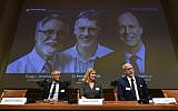 Nobel Assembly members (L-R) Patrik Ernfors, Anna Wedell and Randall Johnson sit in front of a screen displaying the winners of the 2019 Nobel Prize in Physiology or Medicine (L-R) Gregg Semenza, Peter Ratcliffe and William Kaelin after their names were announced during a press conference at the Karolinska Institute in Stockholm, Sweden, on October 7, 2019. (Jonathan NACKSTRAND / AFP)