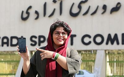 Iranian sports journalist Raha Pourbakhsh shows purchased electronic tickets for the Iran - Cambodia World Cup 2022 soccer qualifier match during an interview with AFP in front of Azadi stadium in the capital Tehran on October 8, 2019. (ATTA KENARE / AFP)