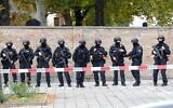 Policemen stand in front of a wall of the Jewish cemetery close to the site of a shooting in Halle an der Saale, eastern Germany, on October 9, 2019 (Sebastian Willnow / dpa / AFP) / Germany OUT