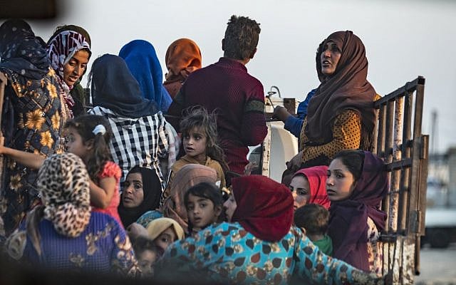 Civilians flee amid Turkish bombardment on Syria's northeastern town of Ras al-Ain in the Hasakeh province along the Turkish border on October 9, 2019 (Delil SOULEIMAN / AFP) Civilians flee amid Turkish bombardment on Syria's northeastern town of Ras al-Ain in the Hasakeh province along the Turkish border on October 9, 2019 (Delil SOULEIMAN / AFP)