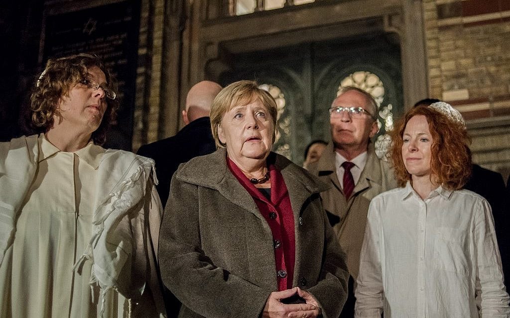 German Chancellor Angela Merkel (C) talks to Rabbi Gesa Ederberg (L) and other members of the Jewish community at a vigil outside the New Synagogue in Berlin on October 9, 2019. (Anton Roland LAUB/AFP)