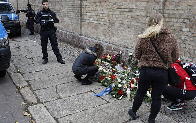 People place flowers at a makeshift memorial in front of the synagogue in Halle, eastern Germany, on October 10, 2019, one day after the attack where two people were shot dead. (Axel Schmidt/AFP) People place flowers at a makeshift memorial in front of the synagogue in Halle, eastern Germany, on October 10, 2019, one day after the attack where two people were shot dead. (Axel Schmidt/AFP)