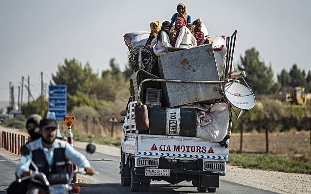 Syrian Arab and Kurdish civilians arrive to Tall Tamr town, in the Syrian northwestern Hasakeh province, after fleeing Turkish bombardment on the northeastern towns along the Turkish border on October 10, 2019. (Delil Souleiman/AFP) Syrian Arab and Kurdish civilians arrive to Tall Tamr town, in the Syrian northwestern Hasakeh province, after fleeing Turkish bombardment on the northeastern towns along the Turkish border on October 10, 2019. (Delil Souleiman/AFP)