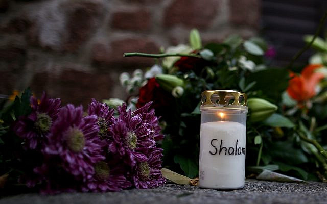 Candles and flowers are seen at a makeshift memorial in front of the synagogue in Halle, eastern Germany, on October 10, 2019, one day after the attack where two people were shot dead in an anti-Semitic attack. (Ronny Hartmann/AFP) Candles and flowers are seen at a makeshift memorial in front of the synagogue in Halle, eastern Germany, on October 10, 2019, one day after the attack where two people were shot dead in an anti-Semitic attack. (Ronny Hartmann/AFP)