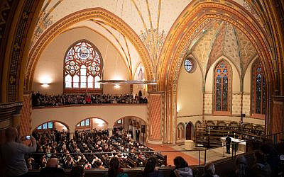 Mourners attend a vigil on October 10, 2019, in commemoration of the Halle shooting victims at the Pauluskirche church in Halle, eastern Germany, one day after the deadly anti-Semitic shooting. (Soeren Stache/DPA/AFP)