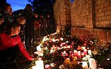 Mourners light candles on October 10, 2019, at the synagogue in Halle, eastern Germany, one day after a deadly anti-Semitic shooting. (Ronny Hartmann/AFP)