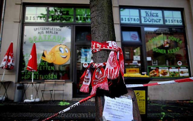 Scarves of German soccer clubs Hallescher FC and Rot-Weiss Erfurt are seen wrapped around a tree on October 10, 2019, outside the doner kebab restaurant in Halle, eastern Germany, that was one of the sites of an anti-Semitic shooting in which two people were killed. (Ronny Hartmann/AFP) Scarves of German soccer clubs Hallescher FC and Rot-Weiss Erfurt are seen wrapped around a tree on October 10, 2019, outside the doner kebab restaurant in Halle, eastern Germany, that was one of the sites of an anti-Semitic shooting in which two people were killed. (Ronny Hartmann/AFP)