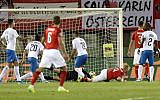 Austria's defender Martin Hinteregger (C) scores during the UEFA Euro 2020 Group G qualification football match Austria v Israel in Vienna on October 10, 2019. (HERBERT PFARRHOFER / APA / AFP)