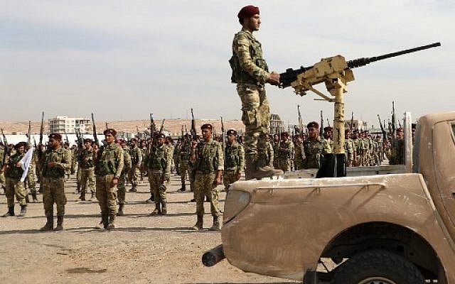 Turkish-backed Syrian rebels gather in al-Bab city in the eastern countryside of Aleppo province on October 11, 2019 as they prepare to take part in Turkey's invasion of northeastern Syria. - Turkish and allied forces faced stiff Kurdish resistance as they battled to seize key border towns, on the third day of a broad offensive that sparked a civilian exodus. (Photo by Zein Al RIFAI / AFP) Turkish-backed Syrian rebels gather in al-Bab city in the eastern countryside of Aleppo province on October 11, 2019 as they prepare to take part in Turkey's invasion of northeastern Syria. - Turkish and allied forces faced stiff Kurdish resistance as they battled to seize key border towns, on the third day of a broad offensive that sparked a civilian exodus. (Photo by Zein Al RIFAI / AFP)