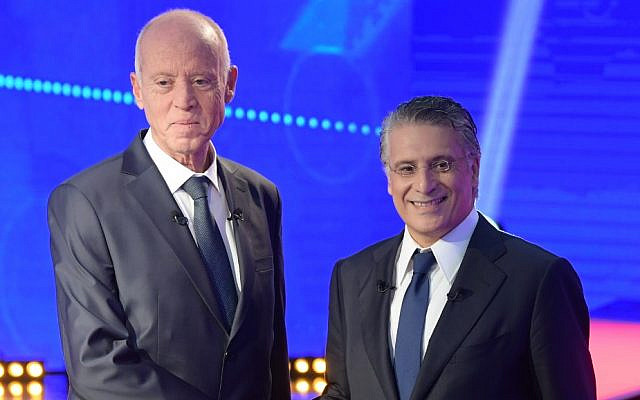Tunisia's presidential candidates Kais Saied (L), 61, an independent conservative academic, and business tycoon Nabil Karoui (R), 56, attend a debate before the second round of the presidential elections on October 11, 2019 in Tunis. (Photo by Fethi Belaid / AFP) Tunisia's presidential candidates Kais Saied (L), 61, an independent conservative academic, and business tycoon Nabil Karoui (R), 56, attend a debate before the second round of the presidential elections on October 11, 2019 in Tunis. (Photo by Fethi Belaid / AFP)