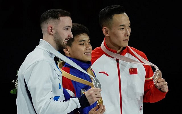 (L-R) 2nd placed Israel's Artem Dolgopyat, winner Philippines' Carlos Edriel Yulo and 3rd placed China's Xiao Ruoteng pose on the podium during the medal ceremony for the Men's floor event at the FIG Artistic Gymnastics World Championships at the Hanns-Martin-Schleyer-Halle in Stuttgart, southern Germany, on October 12, 2019. (Lionel BONAVENTURE / AFP) (L-R) 2nd placed Israel's Artem Dolgopyat, winner Philippines' Carlos Edriel Yulo and 3rd placed China's Xiao Ruoteng pose on the podium during the medal ceremony for the Men's floor event at the FIG Artistic Gymnastics World Championships at the Hanns-Martin-Schleyer-Halle in Stuttgart, southern Germany, on October 12, 2019. (Lionel BONAVENTURE / AFP)