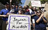 Israeli protesters hold placards during a demonstration against the Turkish military offensive in northeastern Syria, on October 13, 2019 in front of the Turkish embassy in Tel Aviv. (JACK GUEZ / AFP)