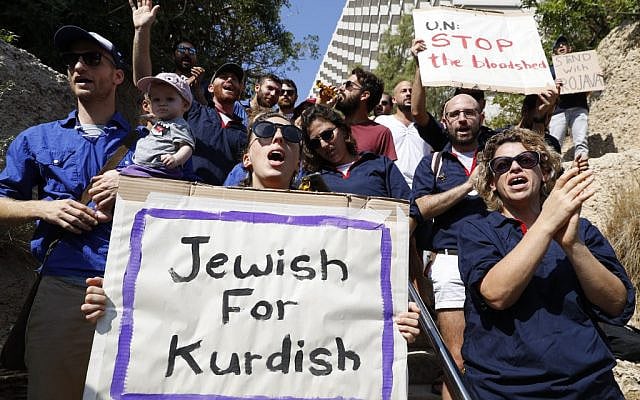 Israeli protesters hold placards during a demonstration against the Turkish military offensive in northeastern Syria, on October 13, 2019 in front of the Turkish embassy in Tel Aviv. (JACK GUEZ / AFP) Israeli protesters hold placards during a demonstration against the Turkish military offensive in northeastern Syria, on October 13, 2019 in front of the Turkish embassy in Tel Aviv. (JACK GUEZ / AFP)