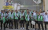 Members of Saudi Arabia's national soccer team are welcomed in the West Bank city of Ramallah on October 13, 2019, where they will play for the first time their match in the Asian qualifiers for the 2022 World Cup against Palestine in two days. (Abbas Momani/AFP)