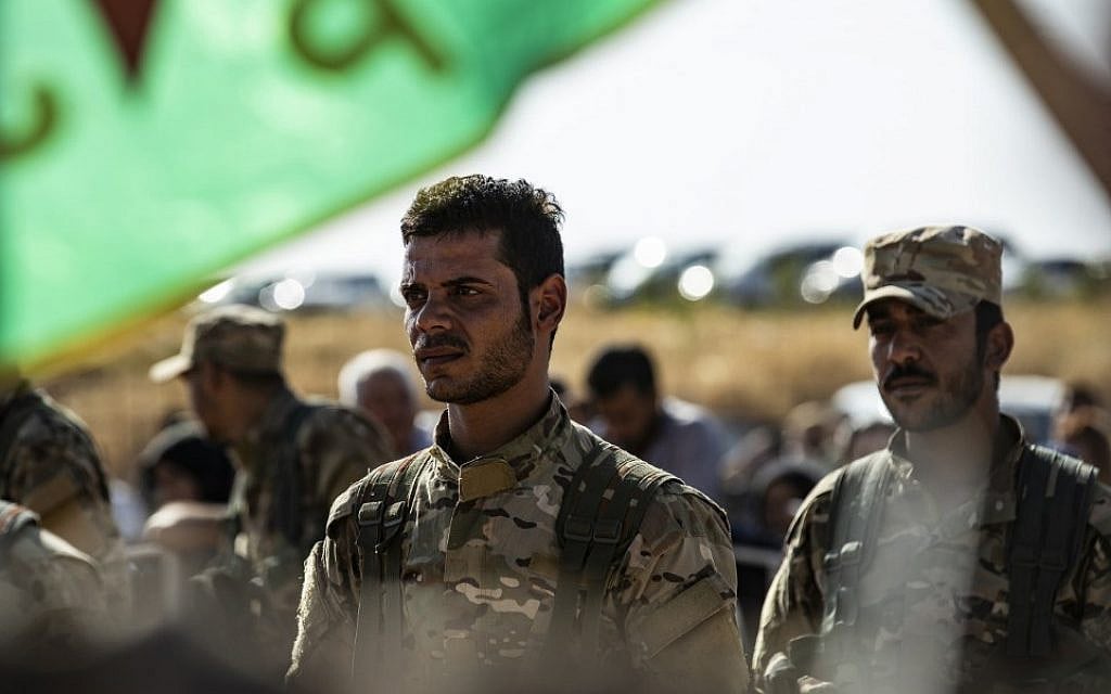 Mourners attend a funeral, for Kurdish political leader Hevrin Khalaf and others including civilians and Kurdish fighters, in the northeastern Syrian Kurdish town of Derik, known as al-Malikiyah in Arabic, on October 13, 2019 (Delil SOULEIMAN / AFP) Mourners attend a funeral, for Kurdish political leader Hevrin Khalaf and others including civilians and Kurdish fighters, in the northeastern Syrian Kurdish town of Derik, known as al-Malikiyah in Arabic, on October 13, 2019 (Delil SOULEIMAN / AFP)