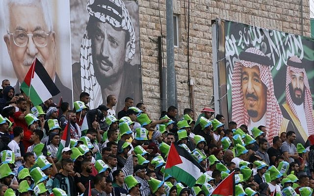 Saudi national football team players listen to their national anthem during a World Cup 2022 Asian qualifying match between Palestine and Saudi Arabia in the West Bank town of al-Ram on October 15, 2019. (HAZEM BADER/AFP)
