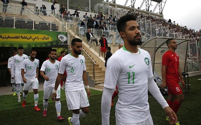 The Saudi and Palestinian national football teams enter the pitch during a World Cup 2022 Asian qualifying match between Palestine and Saudi Arabia in the town of al-Ram in the West Bank on October 15, 2019. (HAZEM BADER / AFP) The Saudi and Palestinian national football teams enter the pitch during a World Cup 2022 Asian qualifying match between Palestine and Saudi Arabia in the town of al-Ram in the West Bank on October 15, 2019. (HAZEM BADER / AFP)