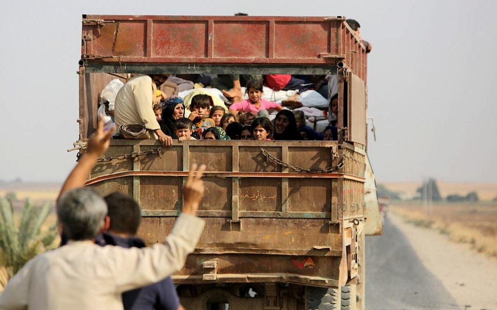 Kurdish civilians flee the town of Kobane on the Turkish border on October 16, 2019 as Turkey continues its assault on Kurdish-held border towns in northeastern Syria. (Bakr Alkasem/AFP)