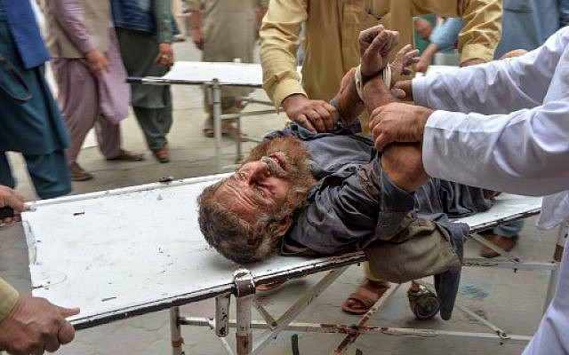 Volunteers carry an injured man on a stretcher to a hospital, following a bomb blast in Haska Mina district of Nangarhar Province on October 18, 2019. (Noorullah Shirzada/AFP) Volunteers carry an injured man on a stretcher to a hospital, following a bomb blast in Haska Mina district of Nangarhar Province on October 18, 2019. (Noorullah Shirzada/AFP)