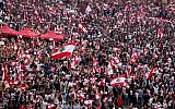 Lebanese demonstrators wave national flags as they take part in a rally in the capital Beirut's downtown district on October 20, 2019. (Patrick Baz/AFP)
