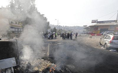 A picture taken on October 21, 2019, shows smoke billowing from a roadblock set by Lebanese protesters on a road in Zouk Mosbeh, north of the capital Beirut. (JOSEPH EID / AFP)