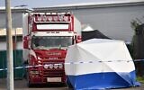 A UK police forensic tent is seen in front of a truck, believed to have originated from Bulgaria, and found to be containing 39 dead bodies, at the scene where it was discovered at Waterglade Industrial Park in Grays, east of London, on October 23, 2019. (Photo by Ben STANSALL / AFP)