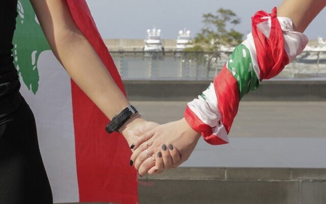 Lebanese protesters hold hands to form a human chain along the coast from north to south as a symbol of unity, during ongoing anti-government demonstrations in Lebanon's capital Beirut on October 27, 2019. (ANWAR AMRO / AFP) Lebanese protesters hold hands to form a human chain along the coast from north to south as a symbol of unity, during ongoing anti-government demonstrations in Lebanon's capital Beirut on October 27, 2019. (ANWAR AMRO / AFP)